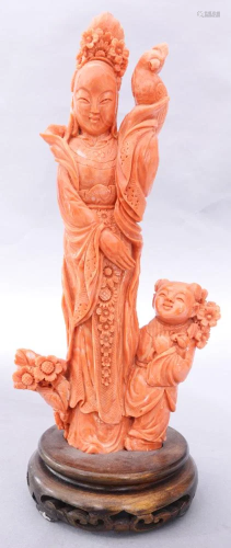 A Chinese carved coral figure of beauty and child a…