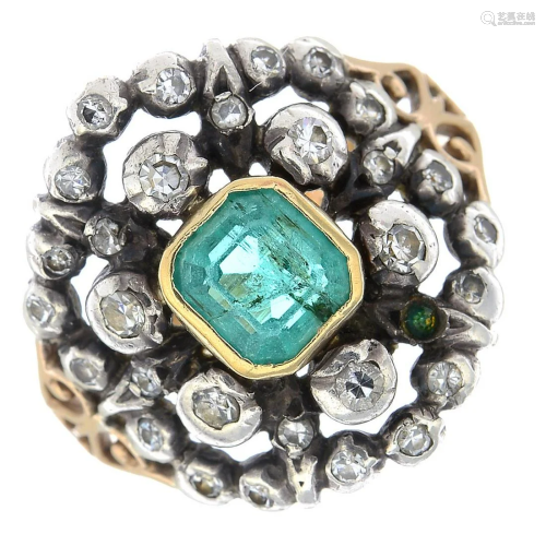 An emerald and diamond cluster ring.Emerald…