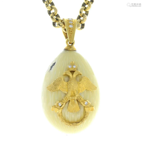 An enamel and diamond egg pendant, suspended from a