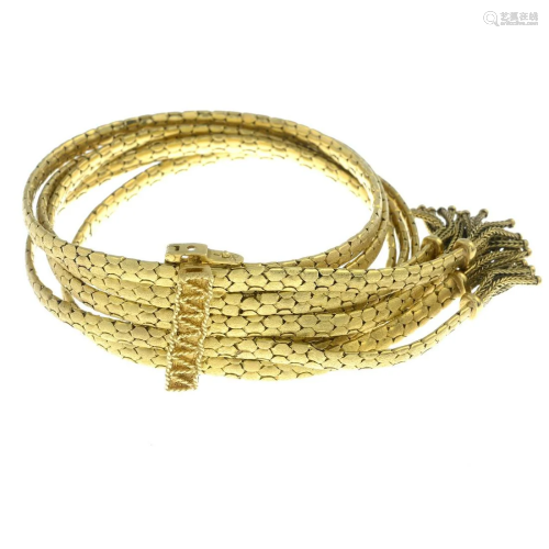A multi-strand bracelet with tassel detail.Length