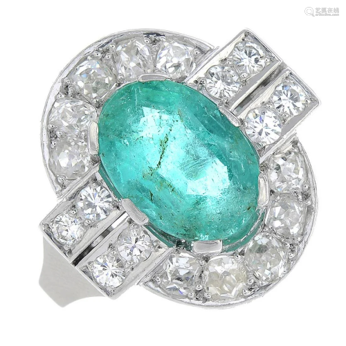 An emerald and old-cut diamond cluster ring.Emerald