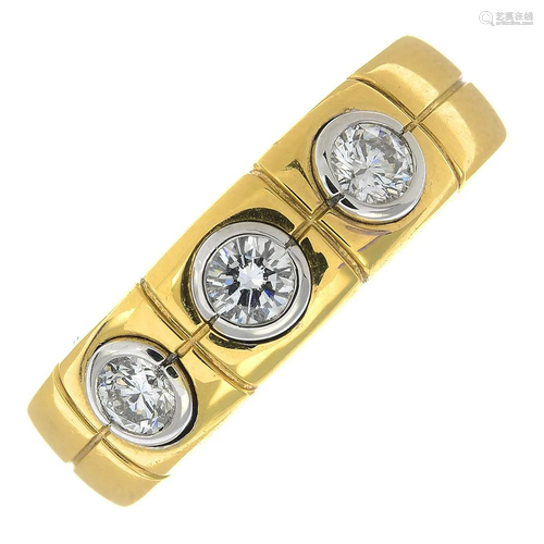 An 18ct gold diamond three-stone band ring.Total