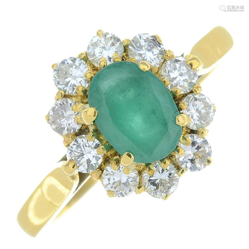 An 18ct gold emerald and diamond cluster ring.Em…