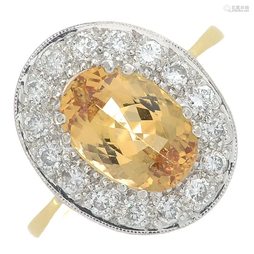 An 18ct gold topaz and diamond cluster ring. Topaz