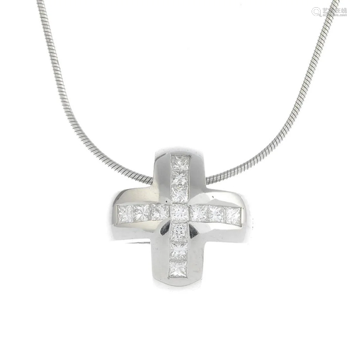 A diamond cross pendant, suspended from an …