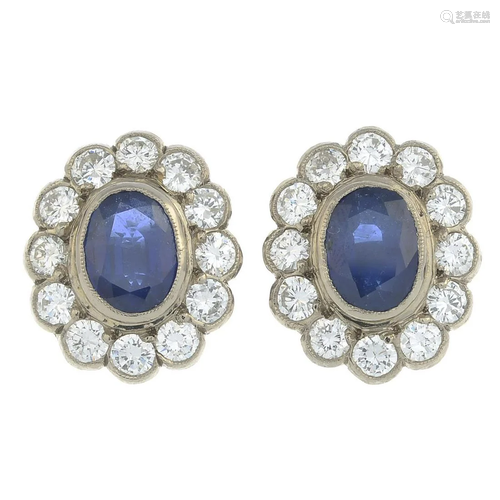 A pair of sapphire and diamond cluster earrings.