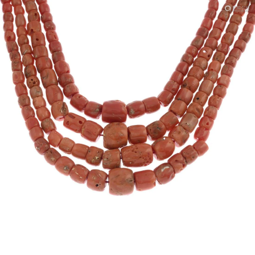 A coral four-row bead necklace.Clasp stamped 750.…