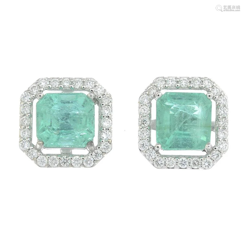 A pair of emerald and brilliant cut diamond cluster