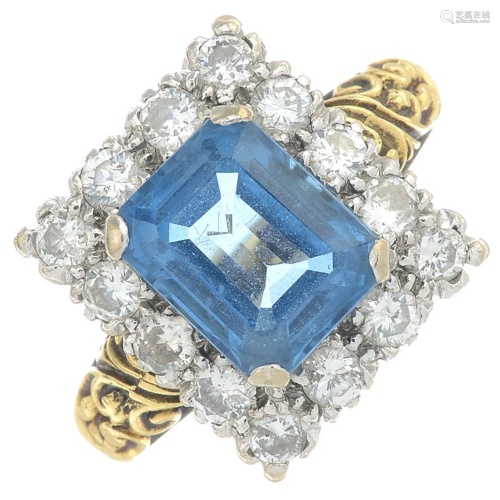 An 18ct gold blue topaz and diamond cluster ring.Topaz
