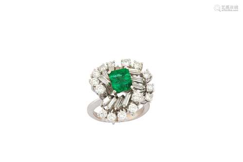 An emerald and diamond cluster ring