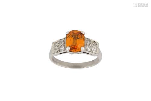 An orange sapphire and diamond ring