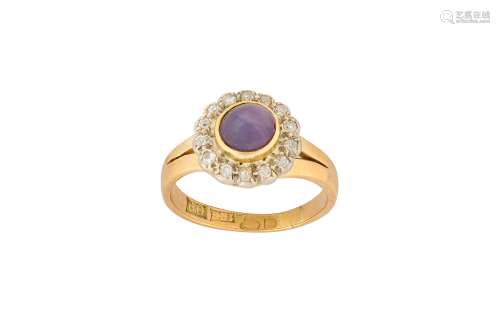 A purple star sapphire and diamond cluster ring
