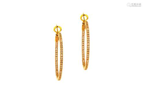 A pair of gold and diamond hoop earrings