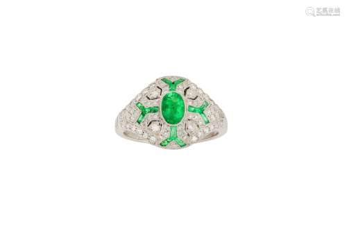 An emerald and diamond dress ring