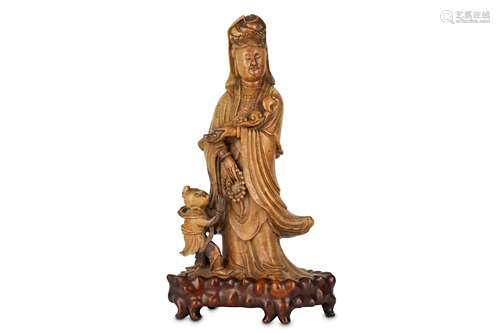 A LARGE CHINESE SOAPSTONE FIGURE OF GUANYIN WITH A CHILD.