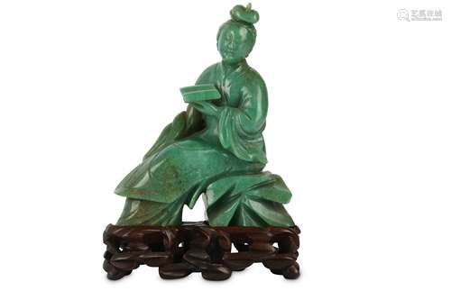 A CHINESE GREEN HARDSTONE CARVING OF A LADY WITH A BOOK.