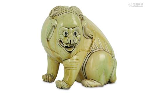 A CHINESE LIME GREEN-GLAZED BISCUIT MODEL OF A MYTHICAL BEAST.