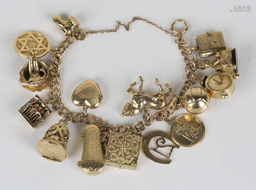 A 9ct gold twin curblink charm bracelet, fitted with fifteen 9ct gold charms, including an alarm