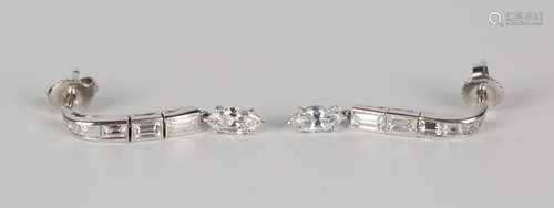 A pair of white gold and diamond pendant earrings, each mounted with a graduated row of five