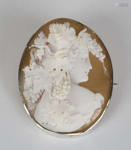 A white metal mounted oval shell cameo, carved as a head and shoulders portrait of a maiden with