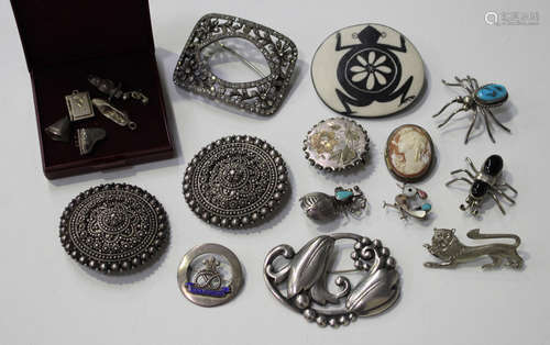 A group of jewellery, including a Georg Jensen style sterling brooch of floral and beaded scroll