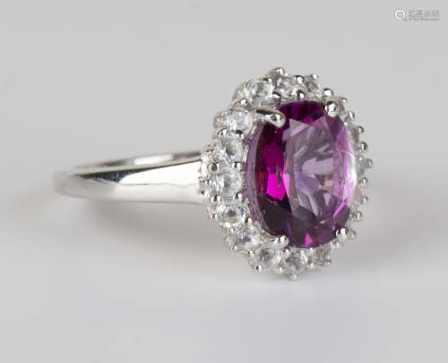 A silver, mauve and colourless gem set oval cluster ring and fourteen further vari-coloured gem