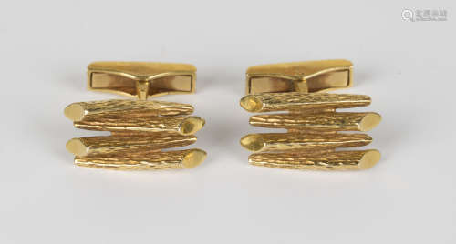A pair of gold cufflinks of four section bark textured design, with folding sprung bar fittings,