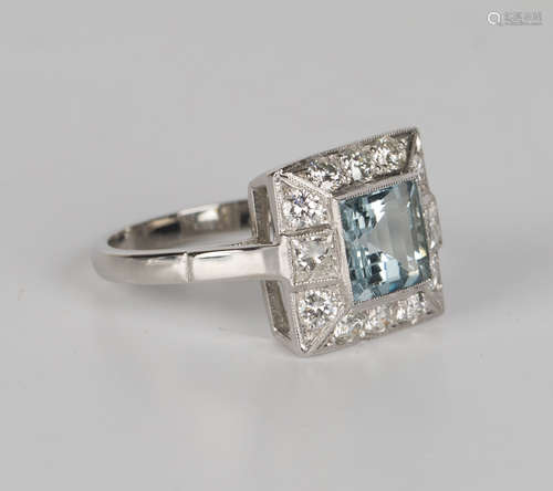 A platinum, aquamarine and diamond square cluster ring, mounted with a square cut aquamarine