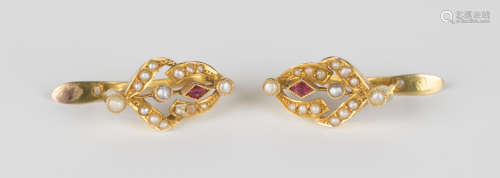 A pair of gold, ruby and seed pearl earrings in an openwork design, with post and hinged fittings,