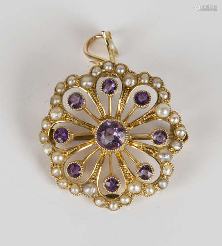 A gold, amethyst and seed pearl pendant brooch of shaped circular form, collet set with a circular