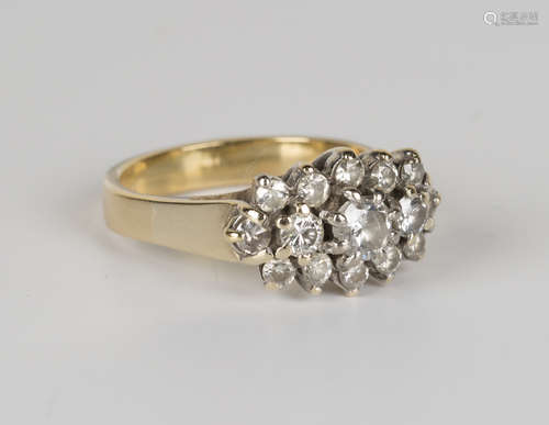 A gold and diamond ring, claw set with the three principal circular cut diamonds within a surround