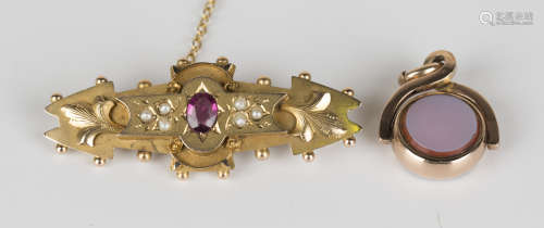 A George V 9ct gold, pink gem and half-pearl set brooch, star set with an oval cut pink gem