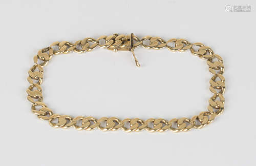 A gold twin faceted curblink bracelet on a snap clasp, detailed '585', length 20.5cm.Buyer’s Premium