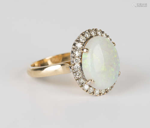 A gold, opal and diamond ring, claw set with an oval opal within a surround of circular cut