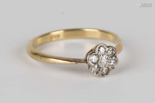 A gold and diamond seven stone cluster ring, detailed '18ct', ring size approx O.Buyer’s Premium