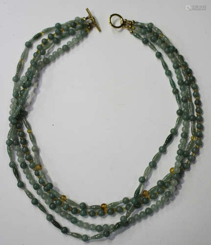 A four row necklace of vari-coloured pale green spherical and tapered baton shaped jade beads, two