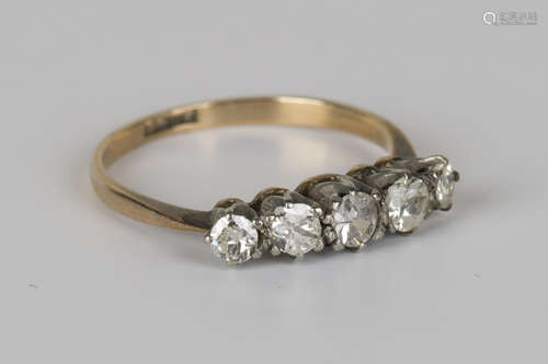 A gold and diamond five stone ring, claw set with a row of circular cut diamonds graduating in