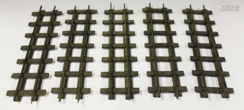 A collection of brass gauge 1 railway track with wooden sleepers, including straights and curves (