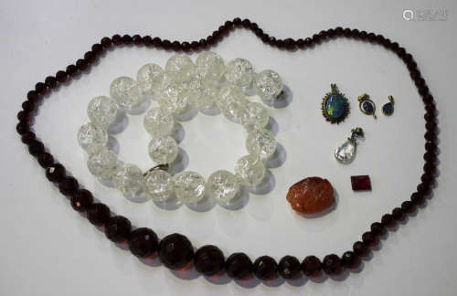 A single row necklace of graduated reconstituted translucent faceted amber beads, length 75cm, a