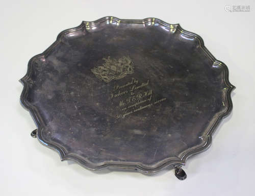 An Elizabeth II silver circular salver with pierced piecrust rim and scroll hoof feet, Sheffield