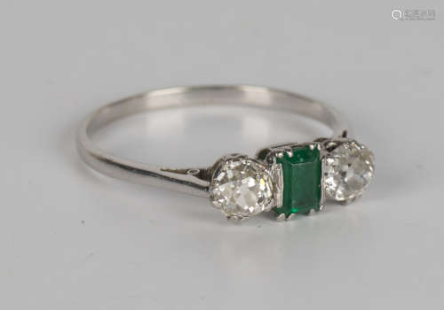A diamond and emerald three stone ring, mounted with a rectangular cut emerald and two cushion cut