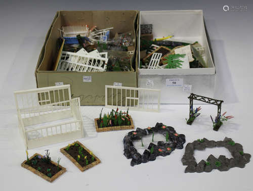 A collection of Britains plastic Floral Miniature Garden items, including two greenhouses, four rock