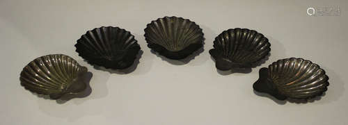 A pair of George IV silver butter shells, on shell feet, London 1820 by WE, length 13.8cm, and three