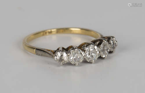 A gold, platinum and diamond five stone ring, mounted with a row of cushion cut diamonds,