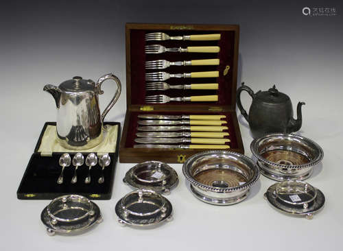 A group of plated items, including a pair of wine coasters with gadrooned rims, a set of six fish