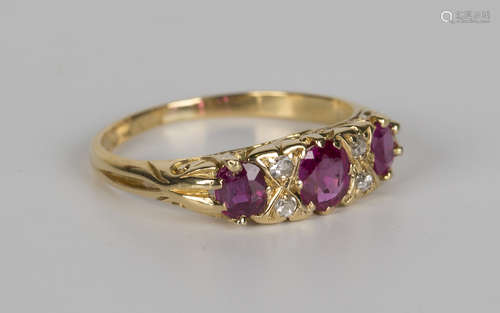 An 18ct gold, ruby and diamond ring, early 20th century, mounted with three cushion shaped rubies