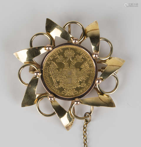 An Austria restruck gold ducat 1915, within a gold pendant brooch fitting in an overlapping scroll