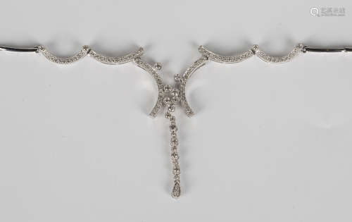 A white gold and diamond necklace, the front of curved bar link design with a central articulated