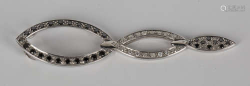A 9ct white gold, black diamond and diamond pendant of folding oval triple section form, mounted