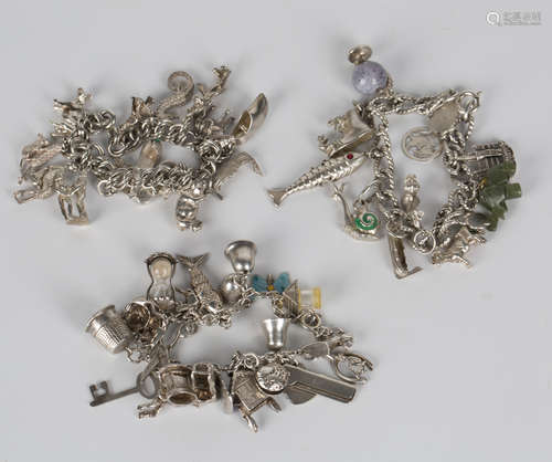 Three silver charm bracelets, fitted with a variety of mostly silver charms.Buyer’s Premium 29.4% (